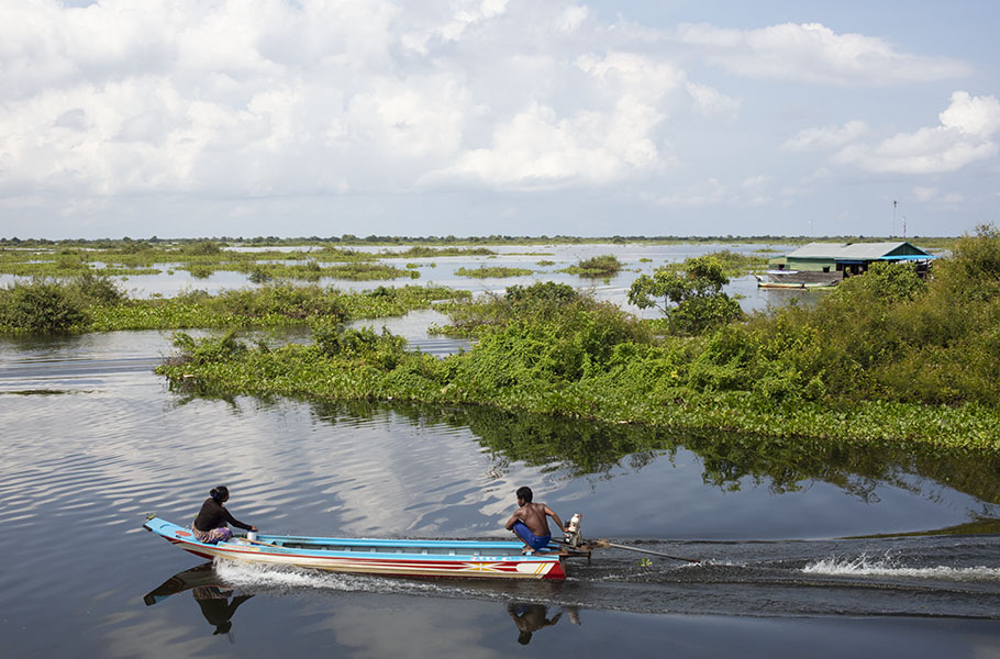 Couple in Long Tailed Boat, Tonle Sap, Cambodia.